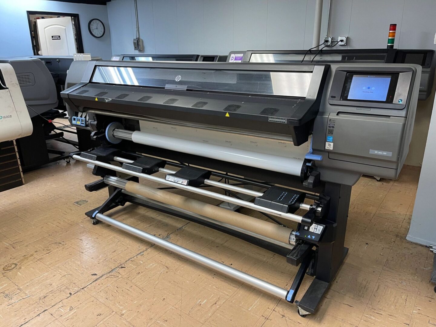 A large printer is sitting in the middle of a room.