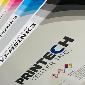 A close up of some papers with the printech center logo