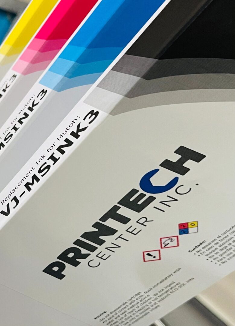 A close up of some papers with the printech center logo