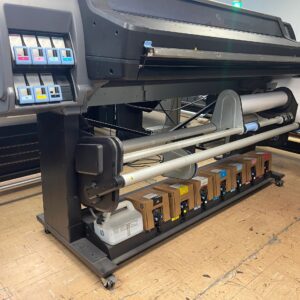 A large printer is sitting on the floor.