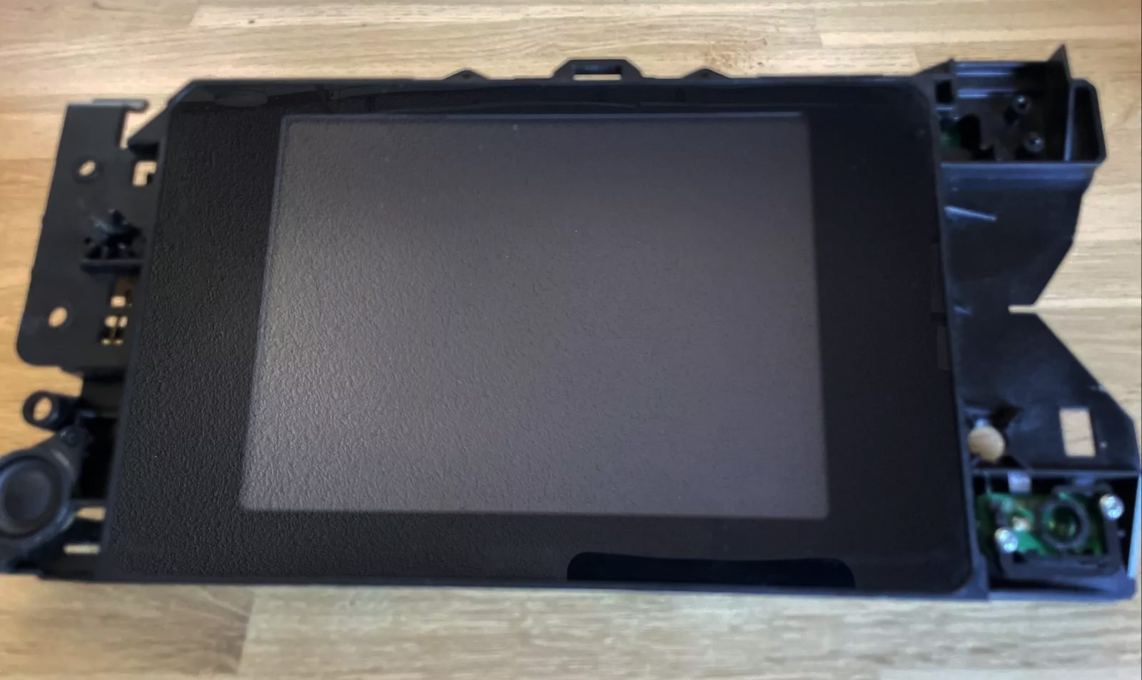 A tablet sitting on top of a wooden table.