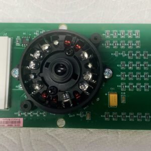 A green circuit board with a camera on top of it.