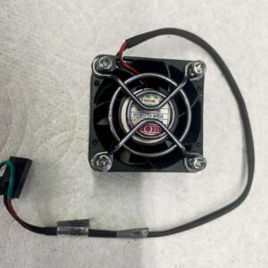 A fan is attached to the side of a wall.