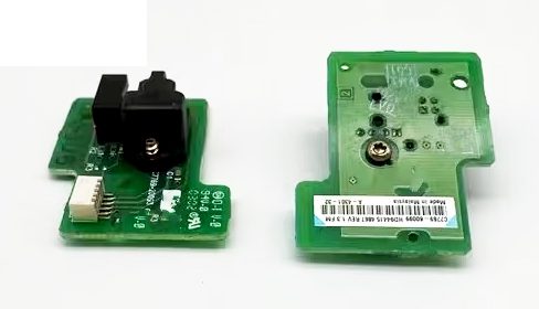 A green circuit board with an electrical device on it.