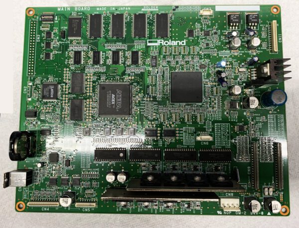 A green computer board with many different electronic components.